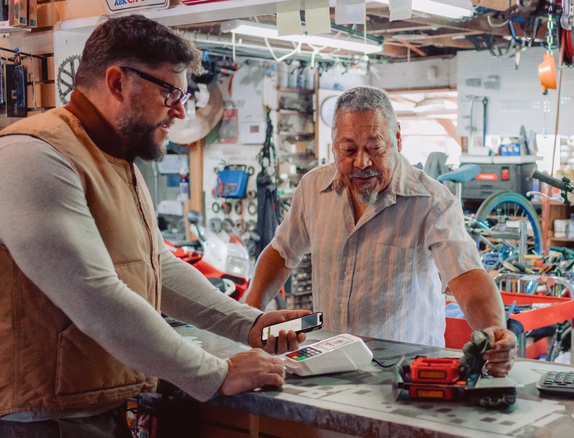 Men discussing purchase in bike shop