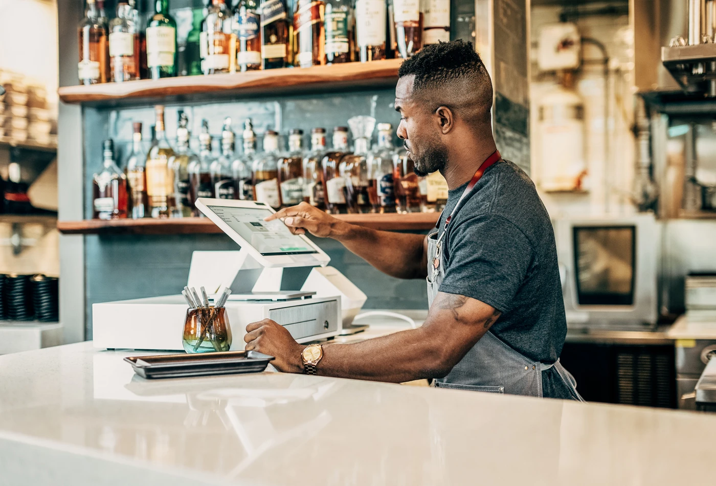 Bartender using POS system in a bar